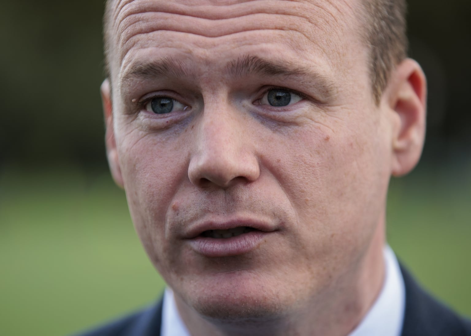 Gordon Lyons says it’s impossible to quantify savings from cost-cutting measure that saw removal of trilingual logos