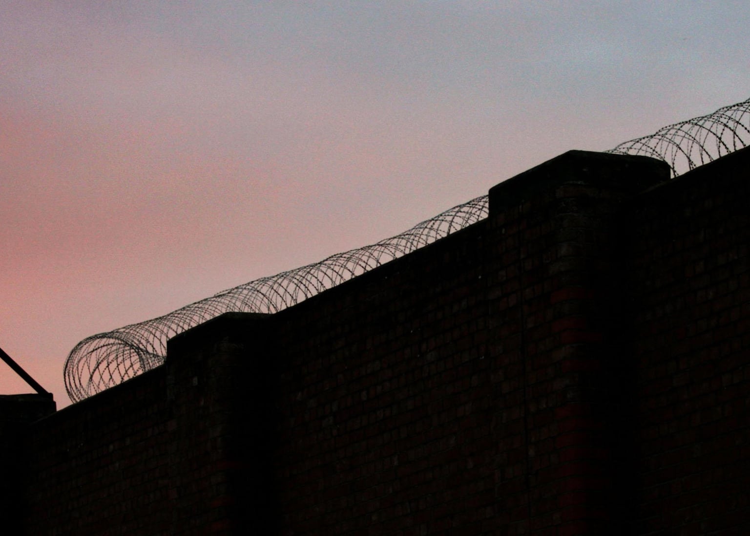 Two of four prisoners still at large were freed by mistake last year