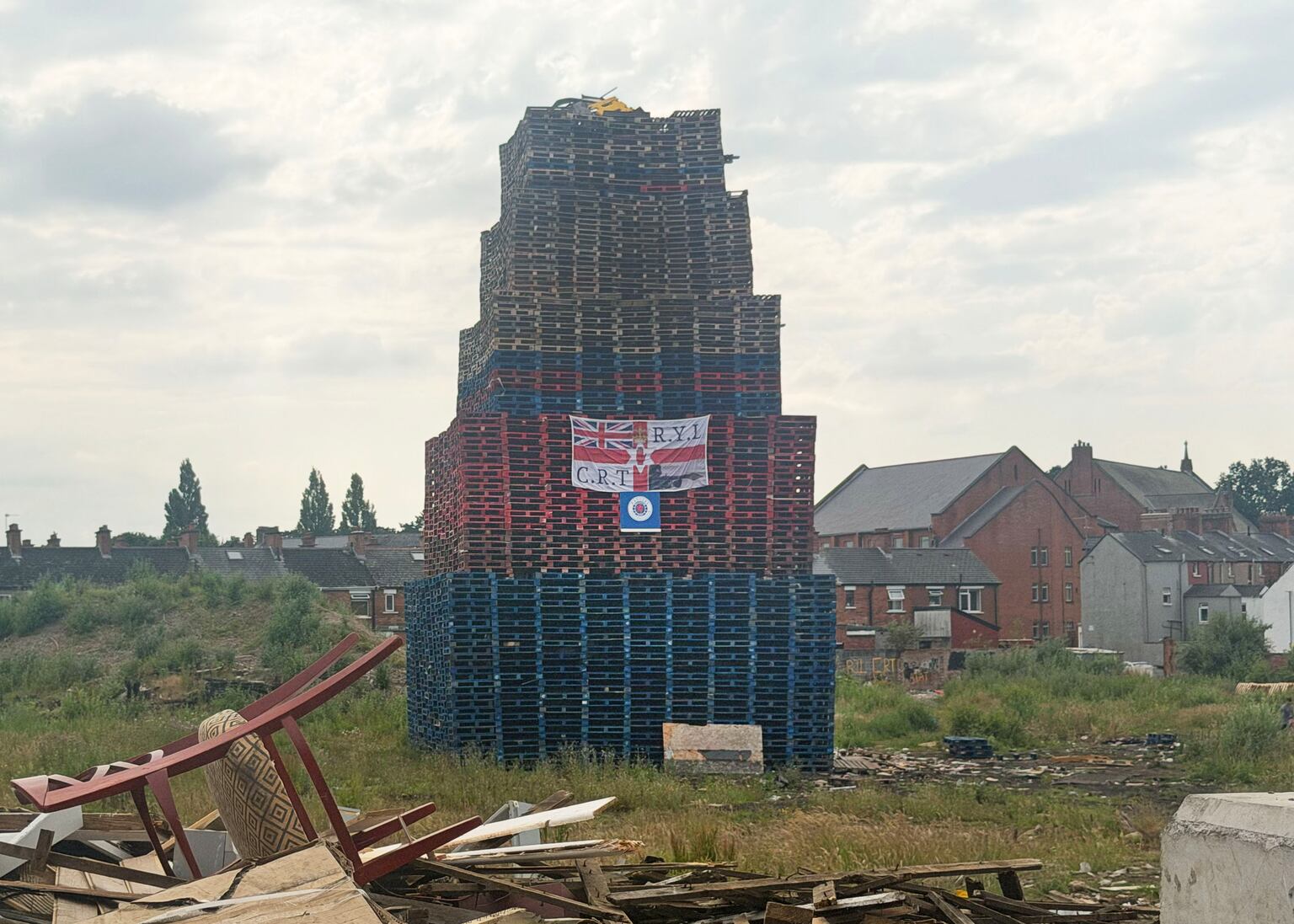 ‘We’re afraid to go on holiday in case our houses burn’ - Locals fear as ever-growing bonfire towers over their homes
