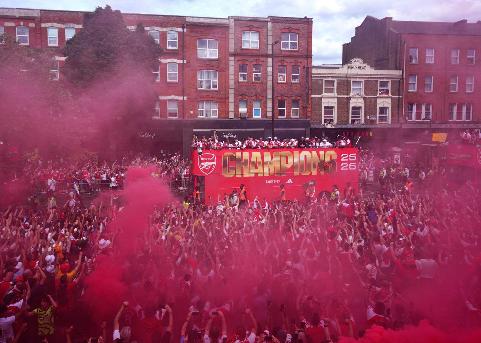 Arsenal put Champions League defeat behind them with open-top bus parade